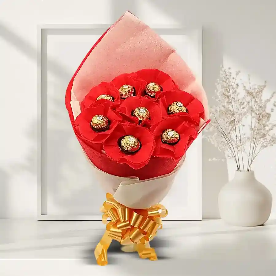 A beautiful arrangement of vibrant red silk roses alongside a box of Ferrero Rochers, symbolizing intense and sweet love.