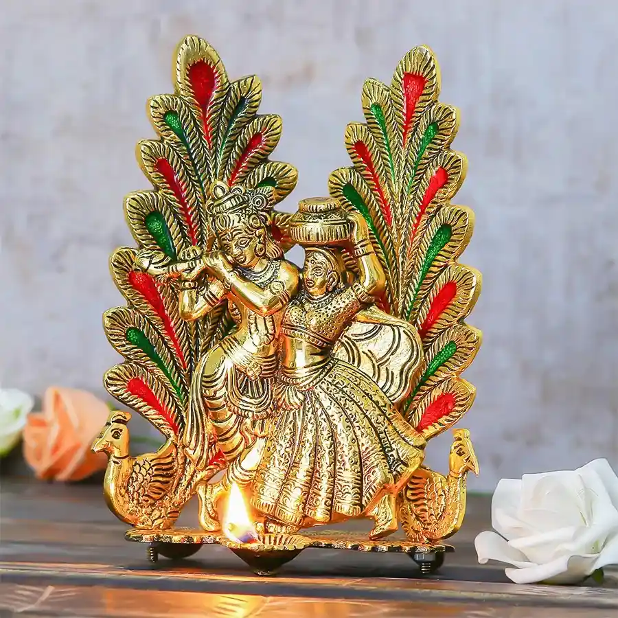 Auspicious Radha Krishna Statue with diya, crafted from golden metal, showcasing intricate peacock design and perfect for gifting.
