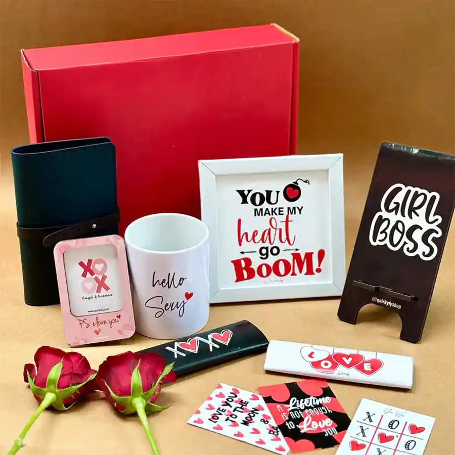Love's Embrace Hamper featuring passport cover, mobile stand, photo frame magnet, ceramic mug, wall hanging frame, chocolates, and Valentine cards.