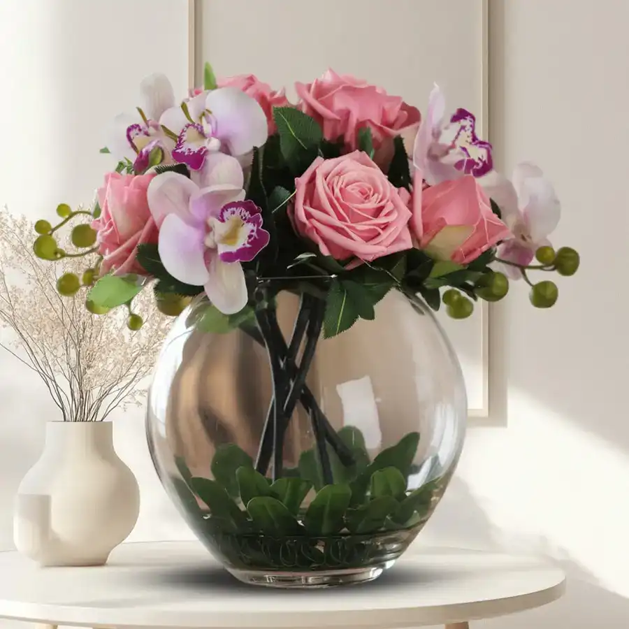 Charming synthetic roses and orchids arranged in a stylish glass vase