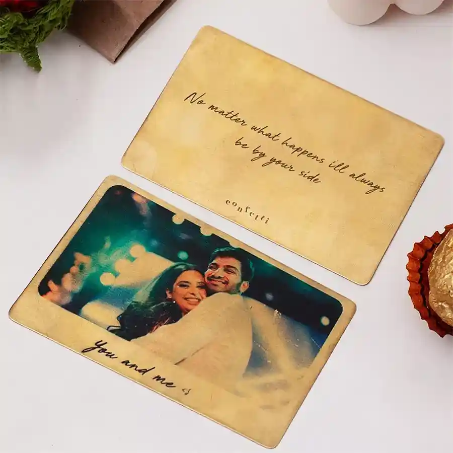 Personalized golden metal card featuring a customized picture and engraved text, perfect as a sentimental keepsake.