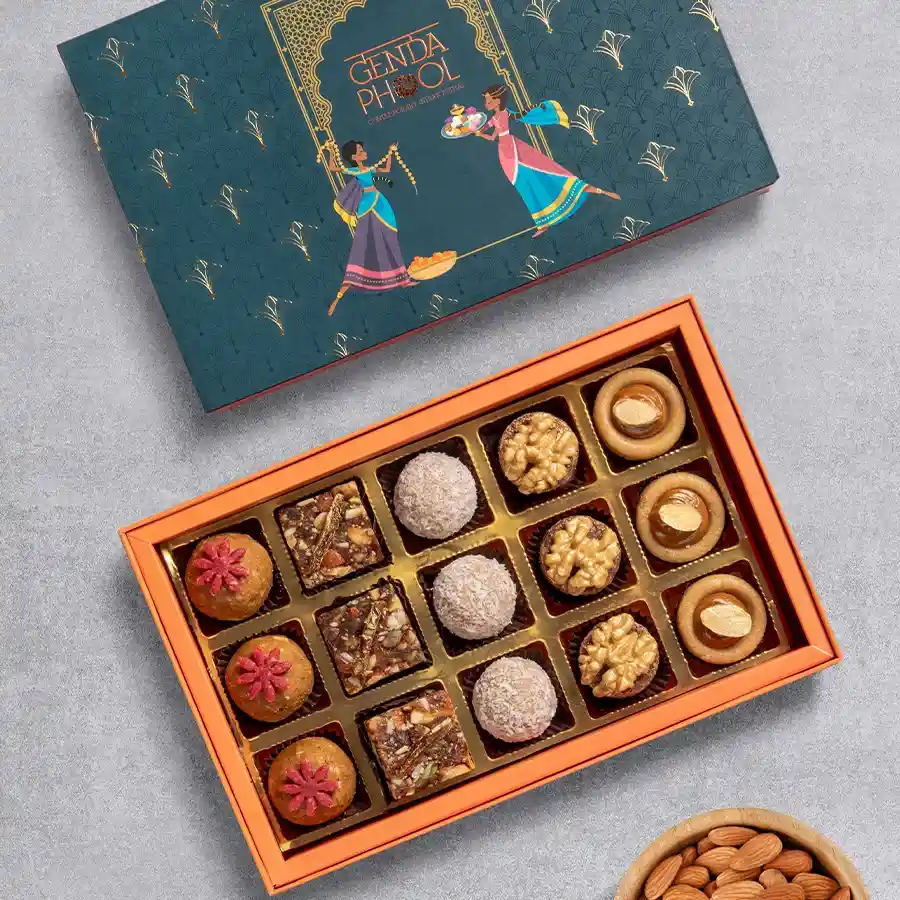 Guiltless Sugar Free Sweet Box featuring assorted mithai pieces including Fig-n-Date, Tropical Delight, Jaggery Laddu, Golden Almond, and Apple Spice.