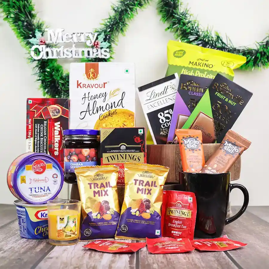 Sweet n Savory Indulgence Hamper filled with gourmet treats, including dark chocolate, cookies, tea, and savory snacks, presented in a reusable basket.