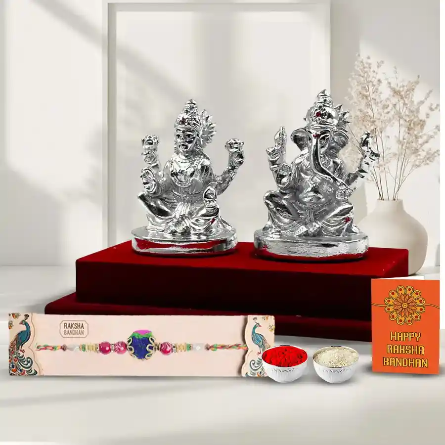 Silver Laxmi Ganesha statue with intricate details and a complimentary Rakhi displayed beside it