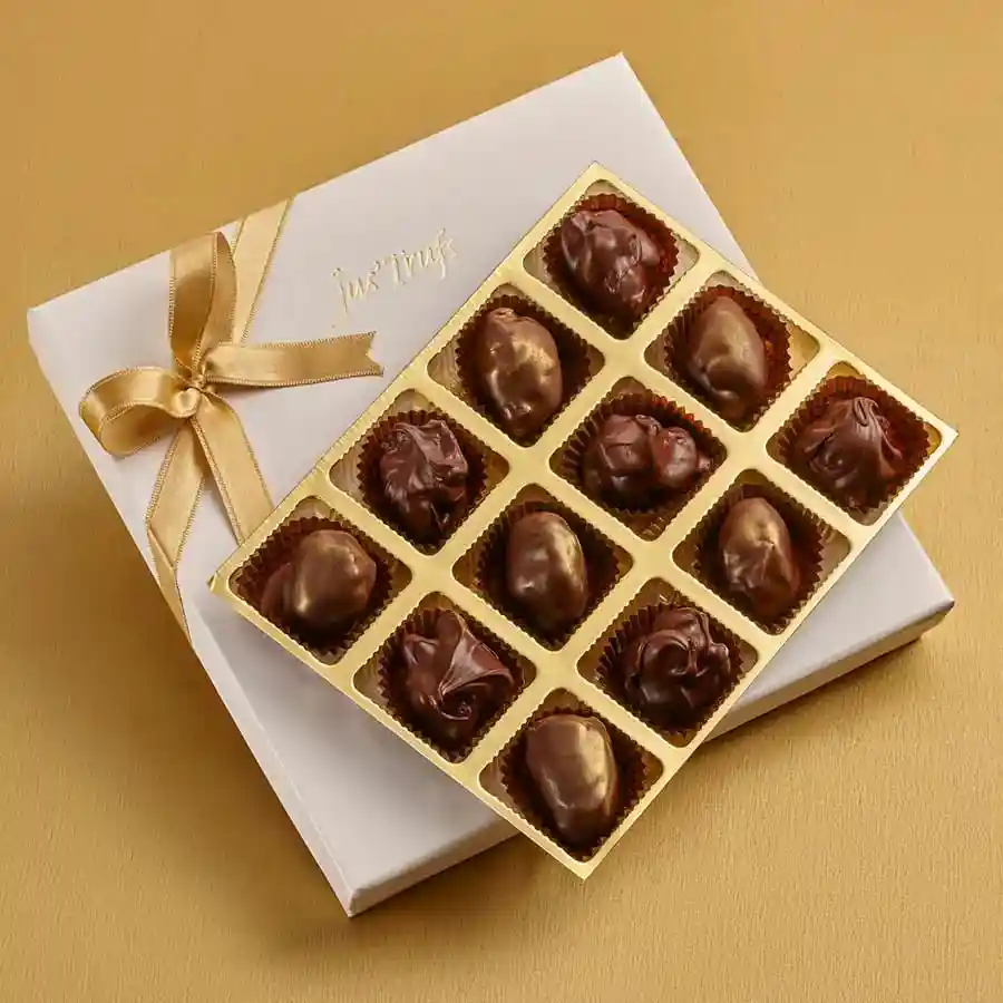 A beautifully arranged box of Yummy Chocolate Treats featuring chocolate-covered dates and crunchy almond rocks, presented in an elegant Mandala box.