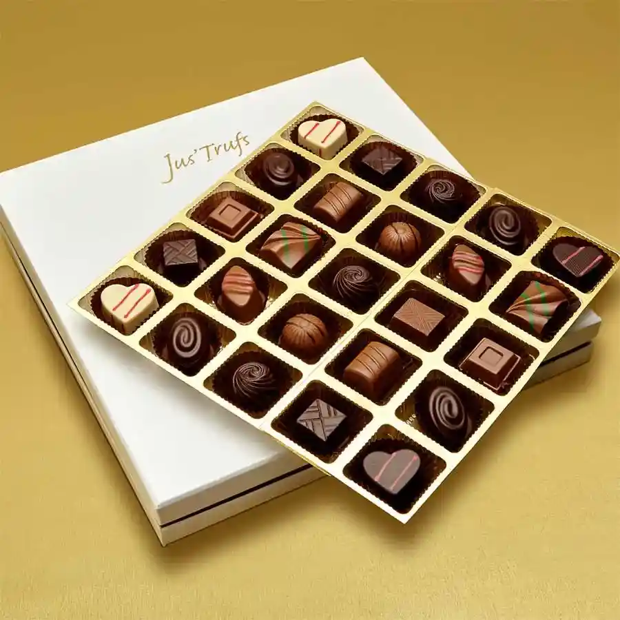 A beautifully arranged box of 25 handcrafted truffles in various flavors, including milk chocolate, mint, strawberry, almond, coffee, dark chocolate, and orange, showcasing an elegant presentation ideal for gifting.