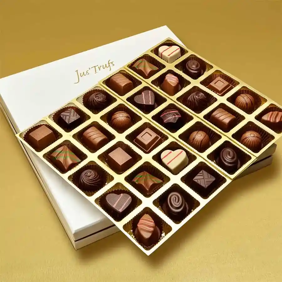 A beautifully arranged box of 30 assorted handcrafted truffles in various flavors.