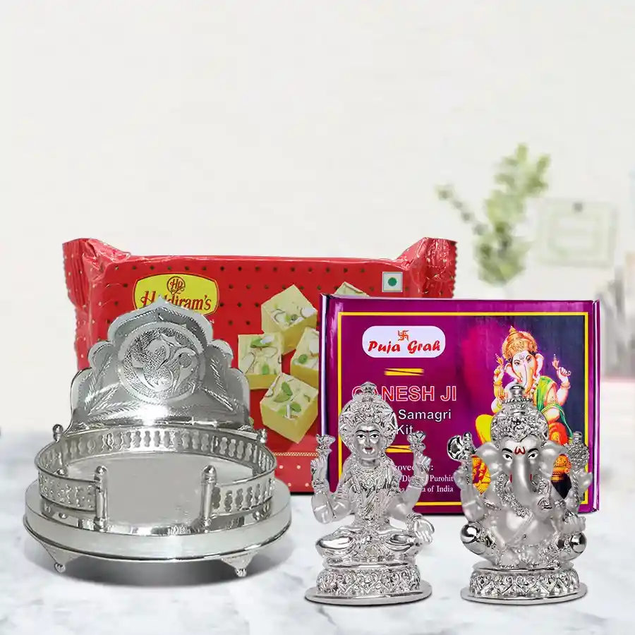 Heartfelt Pooja Gift Collection featuring a silver mandir case, Ganesh Laxmi idol, pooja samagri, and Haldirams Soan Papdi.