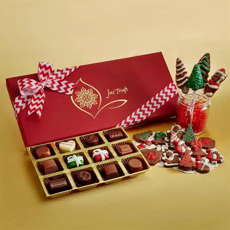 Festive box of Jolly Holiday Chocolate Medley featuring truffles, marzipan, chocolate lollipops, and assorted milk and white chocolate pieces, elegantly presented with holiday-themed decorations.