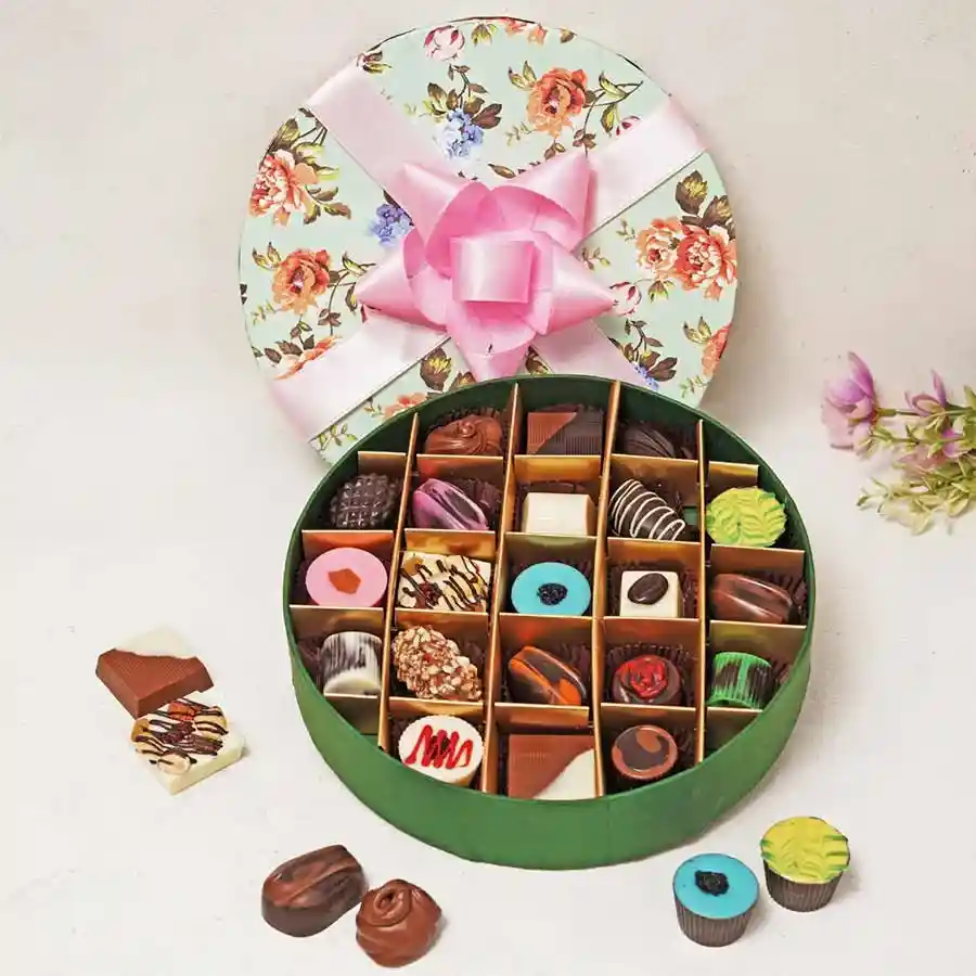 An elegant box containing 21 assorted handcrafted chocolates in various flavors and types, including dark, milk, and white chocolate.
