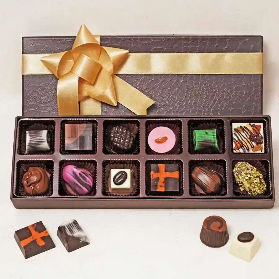 A beautifully arranged box of gourmet assorted chocolates featuring various flavors and textures, including dark and milk chocolates, nuts, and soft-filled centers.