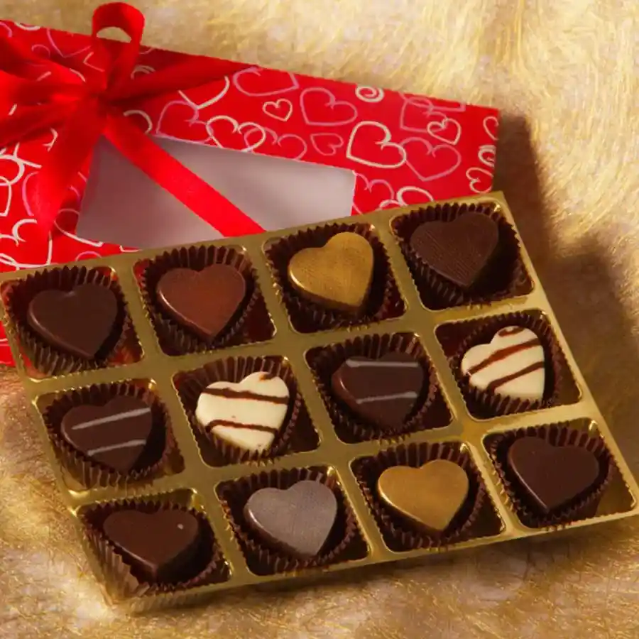 Heart-shaped chocolates in a decorative box with flavors like Mandarin Surprise, Almond, Strawberry Melody, Fruit n Nut, and Heavenly Milk.