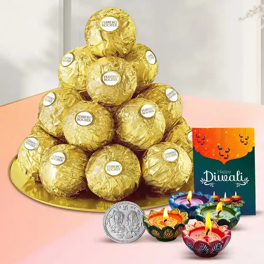 Elegantly arranged Ferrero Rocher chocolates in a golden-plated thali, accompanied by a silver-plated coin, a festive Diwali card, and four diyas.