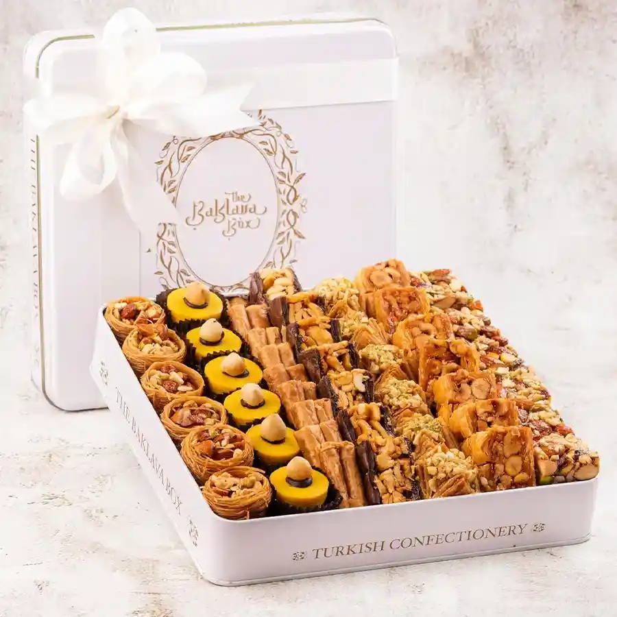 Sweet Moments Assorted Baklava Box in a white tin with baklavas, customized card, and ribbon, showcasing a delightful gift experience.