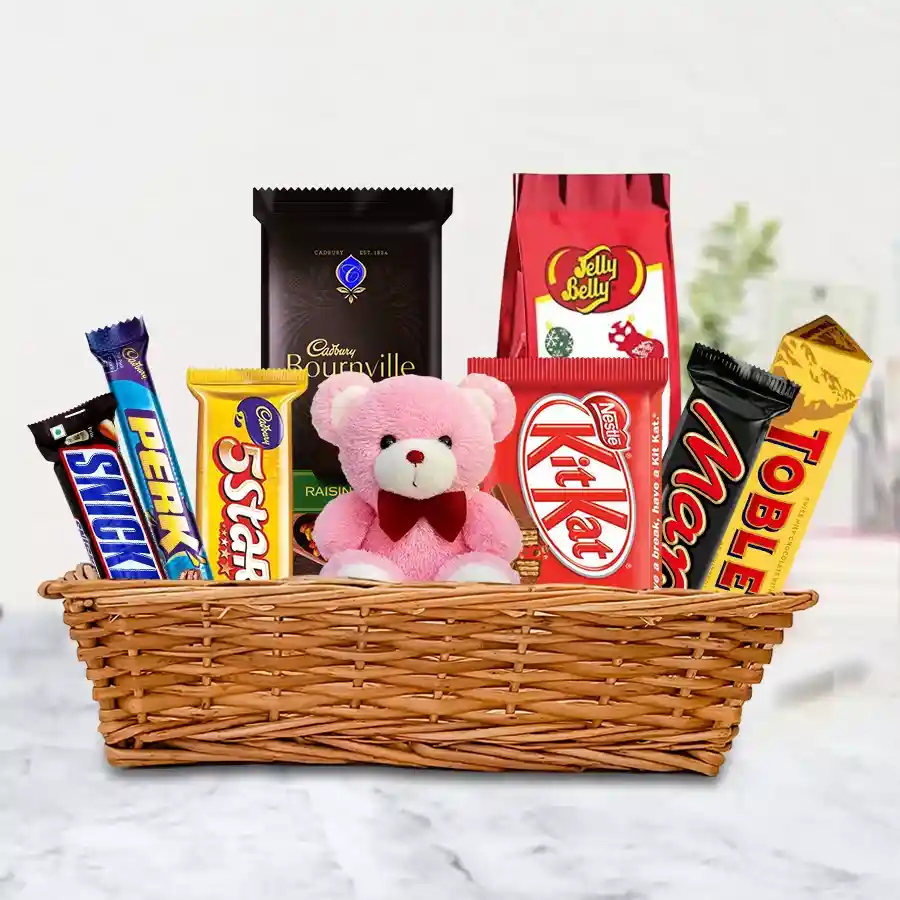 Teddy bear and assorted chocolates in a decorative basket