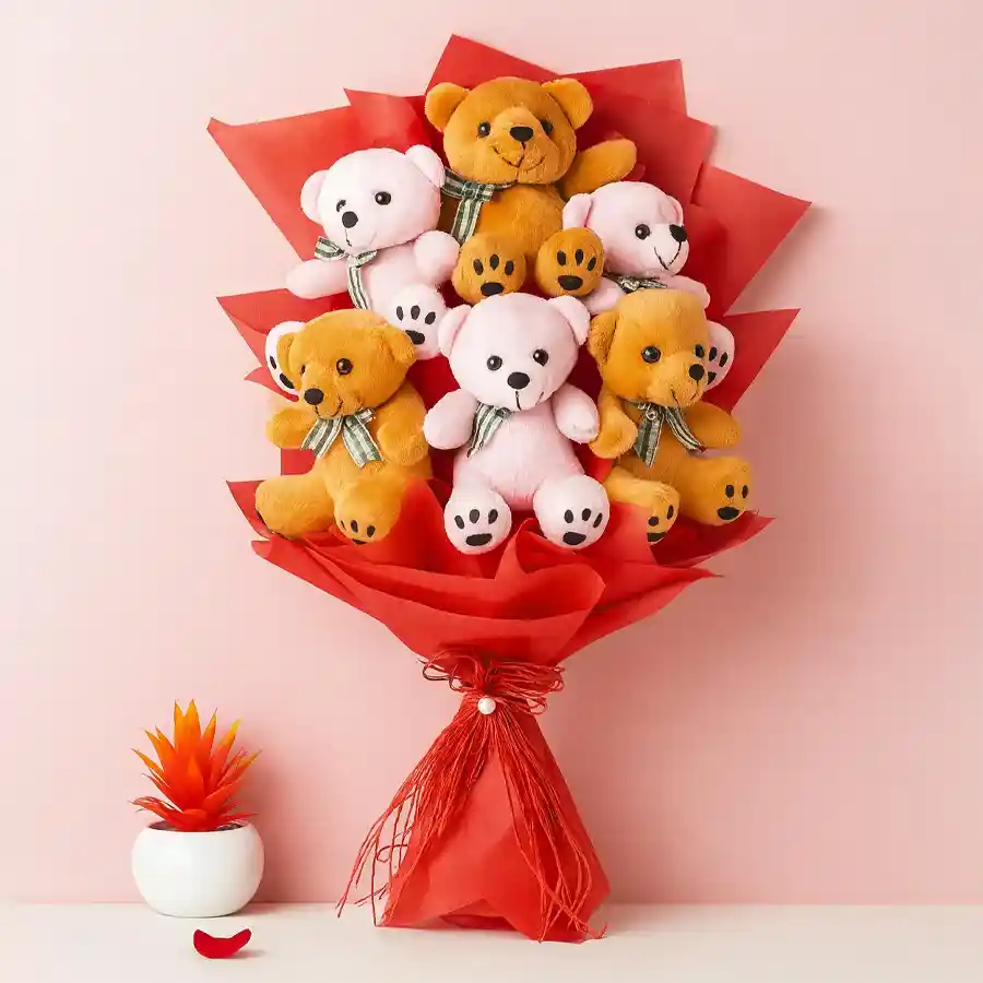 Bouquet of 6 plush teddies wrapped in tissue, conveying love and joy.