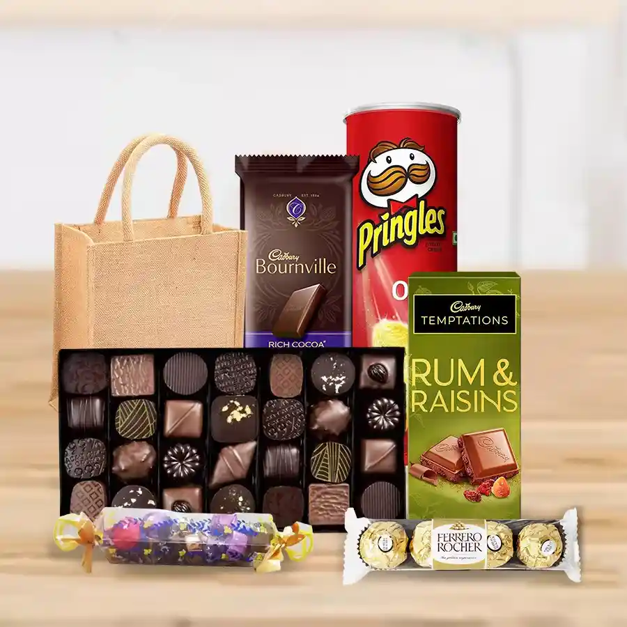 Gift hamper filled with assorted chocolates, Pringle Chips, toffees, and Ferrero Rocher, arranged in a jute bag.