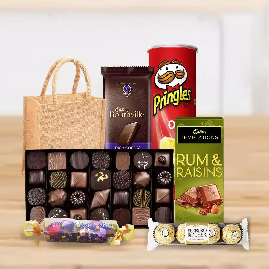A beautifully arranged gift hamper featuring chocolates, toffees, Pringle Chips, and chocolate bars in a jute bag.