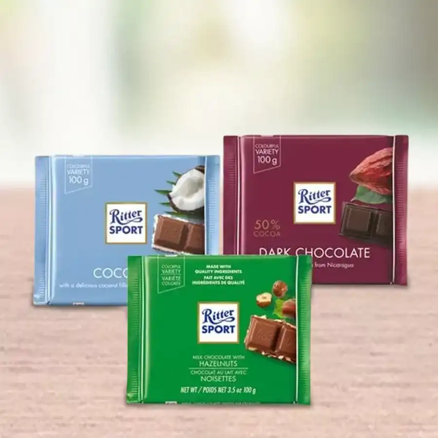 Gift pack of Ritter Sport assorted chocolates featuring Hazelnut, Coconut, and Dark Chocolate bars.