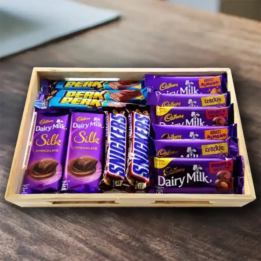 Mixed Chocolates Gift Combo arranged on a premium wooden tray, featuring Cadbury Dairy Milk Silk, Perk, Fruit & Nut, Crackle, Roast Almond, and Snickers bars.