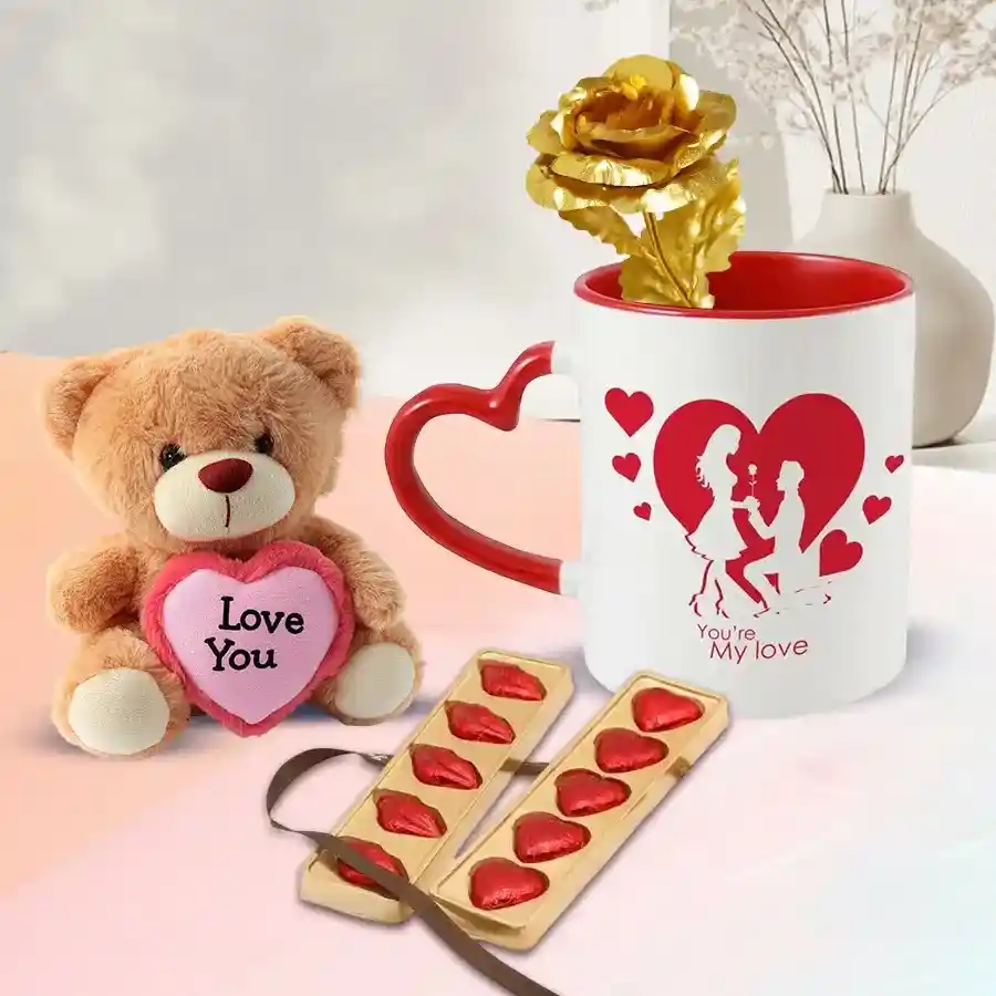 Heart-shaped chocolates, lip-shaped treats, a teddy bear holding an "ILU" heart, a golden rose, and a love-themed coffee mug arranged in a gift bundle.