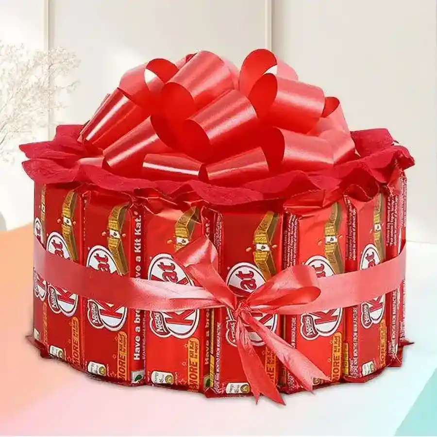 Round shape arrangement of 15 Nestle KitKat bars tied with a vibrant red ribbon.
