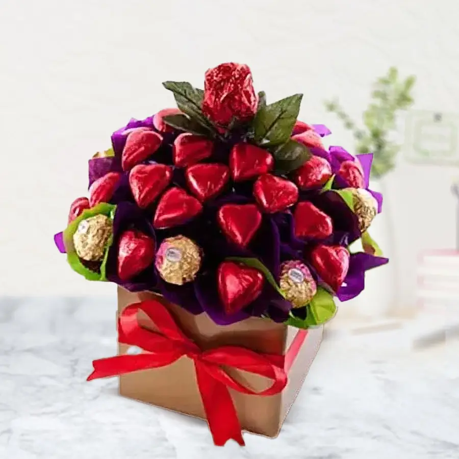 Heart-shaped handmade chocolates and Ferrero Rocher collection arranged in an elegant square box for gifting on special occasions.