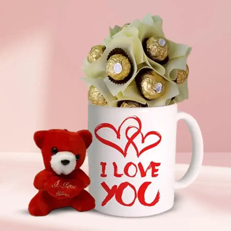 Personalized coffee mug with "I Love You" design, surrounded by eight Ferrero Rocher chocolates and a 6-inch teddy bear on a cozy background.