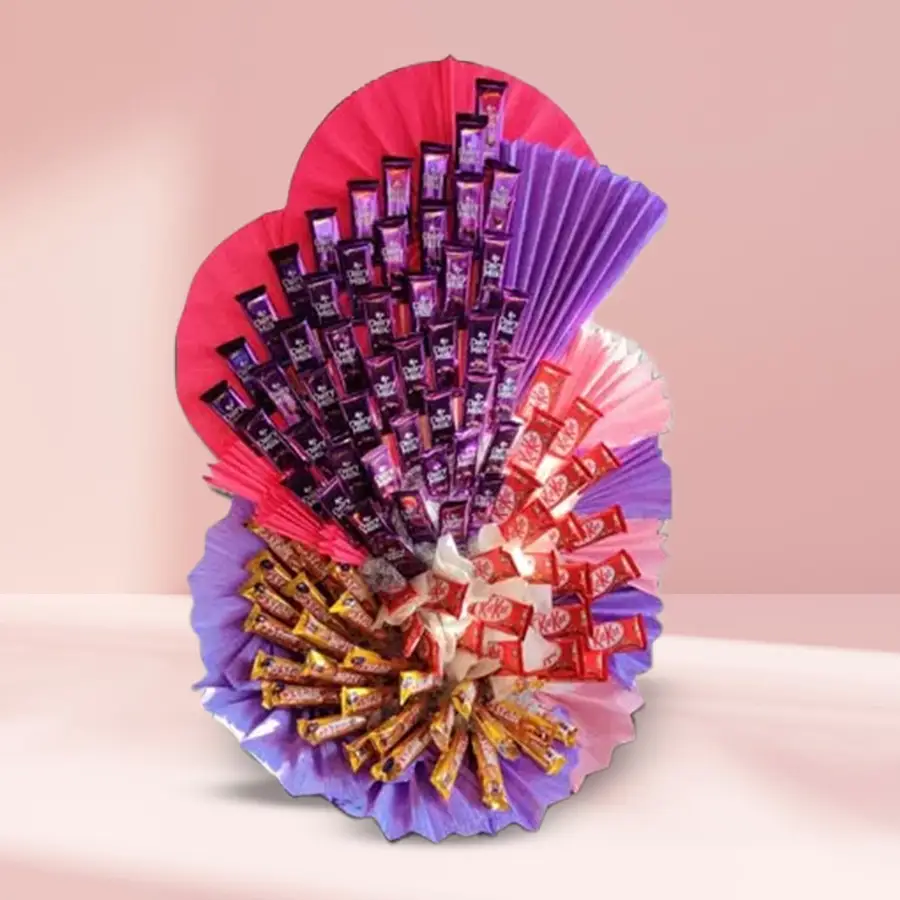 Assorted chocolates arrangement featuring Cadbury Dairy Milk, Nestle Kitkats, and Cadbury Five Stars in a decorative box.