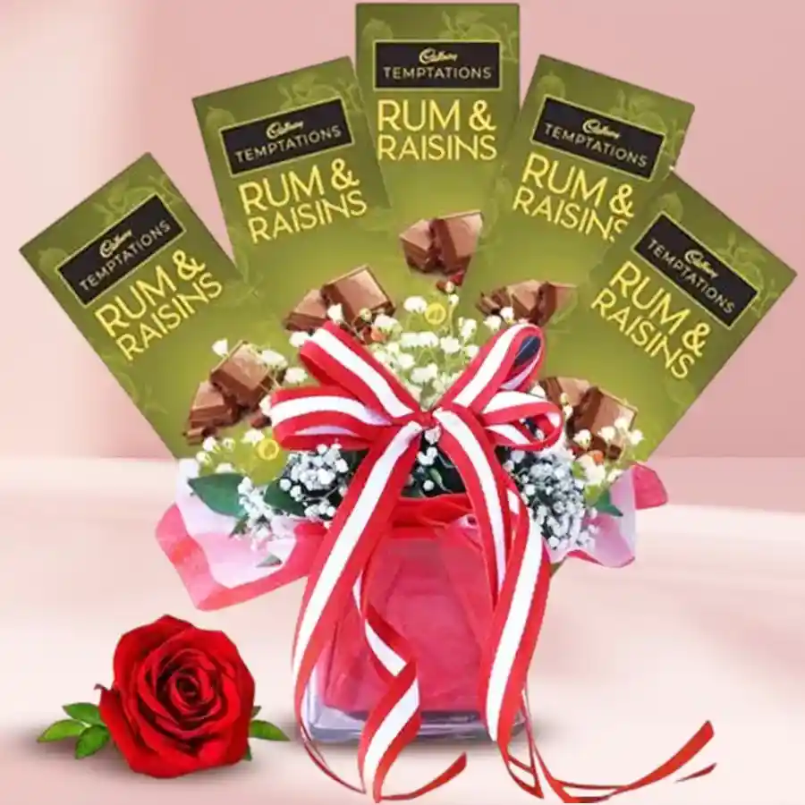 Stunning arrangement featuring a red rose and five Cadbury Temptations chocolates in a glass vase.