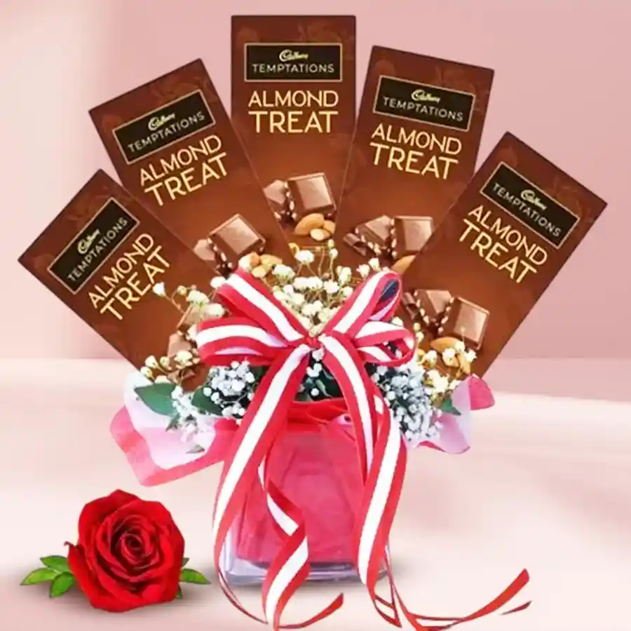 Elegant glass vase featuring 5 Cadbury Temptations Almond Chocolates and a single rose, designed for a sweet gesture.