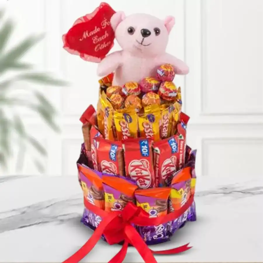 Treasured 4 Layer Chocolates and Teddy Arrangement featuring Kitkat, Crispello, 5 Star, lollipops, and a cute teddy bear with a red ribbon.