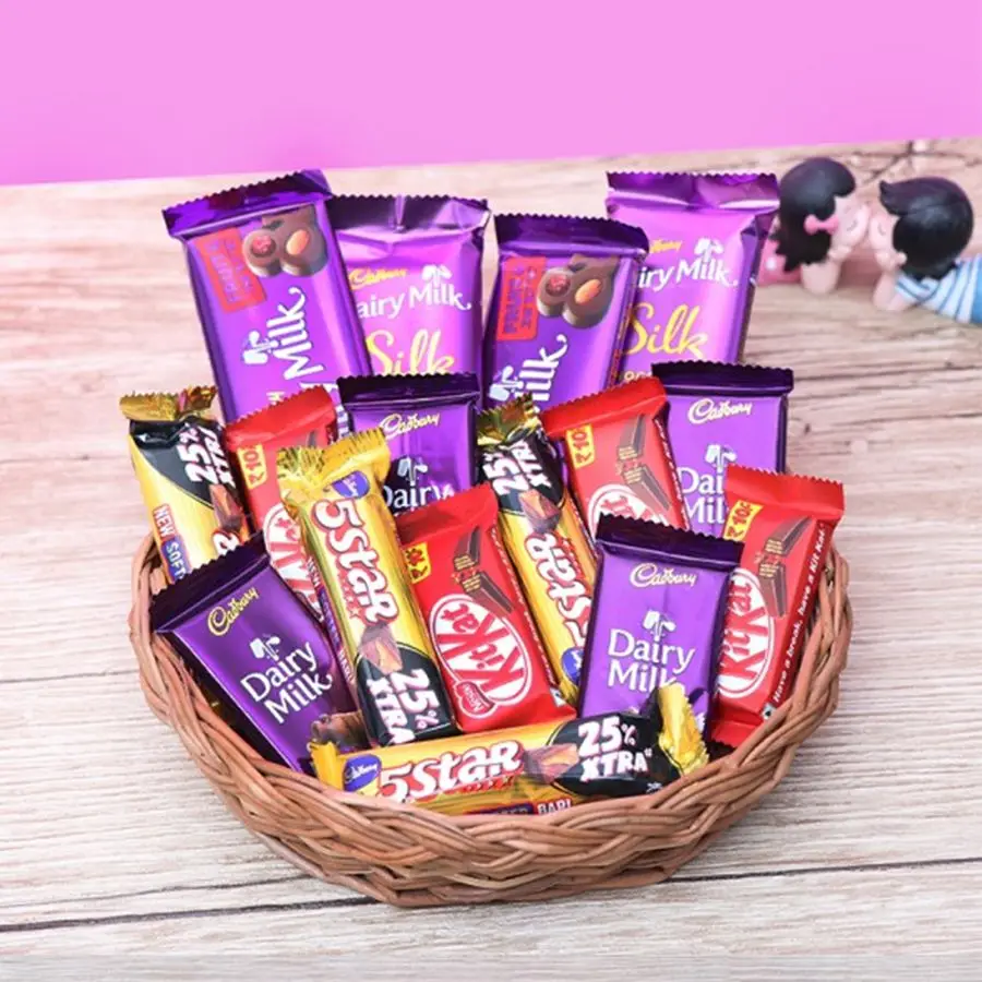 Chocolate Wonderland Gift Basket filled with assorted chocolates and a reusable cane basket.