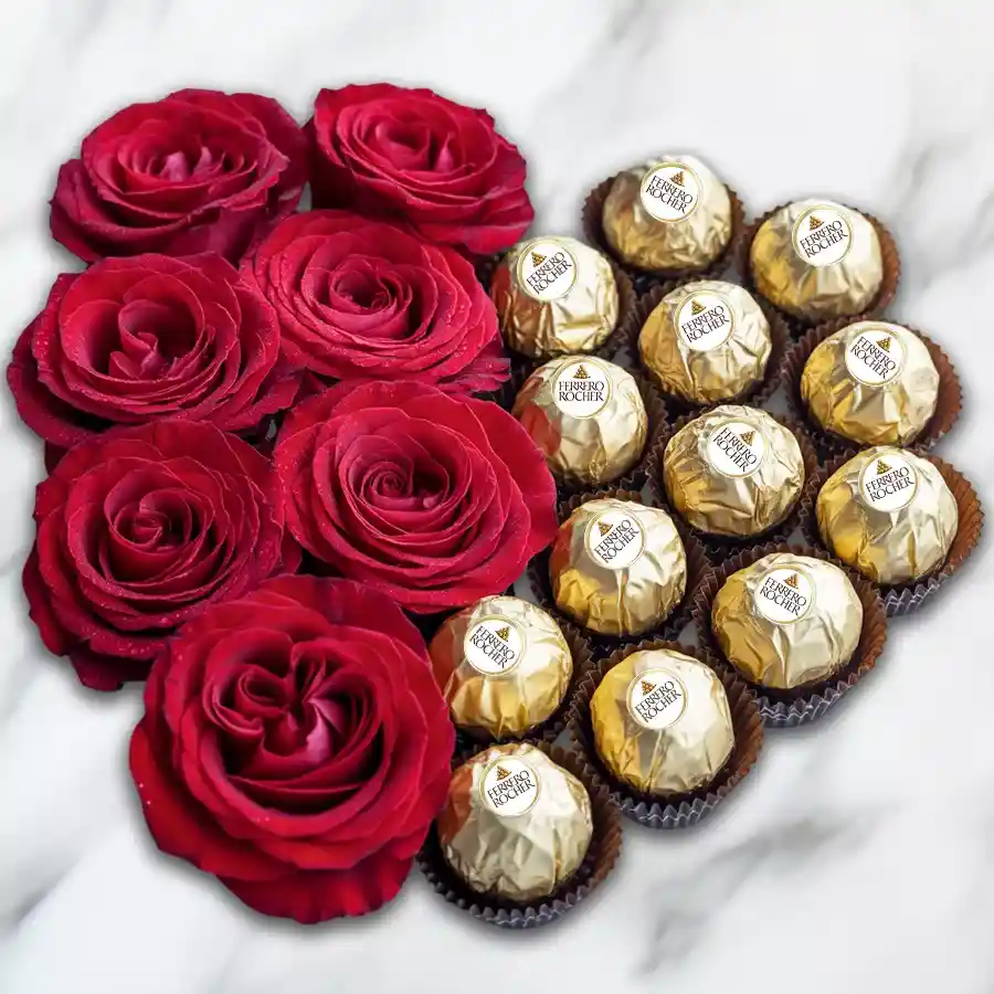Heart-shaped arrangement of Ferrero Rocher chocolates and red roses.