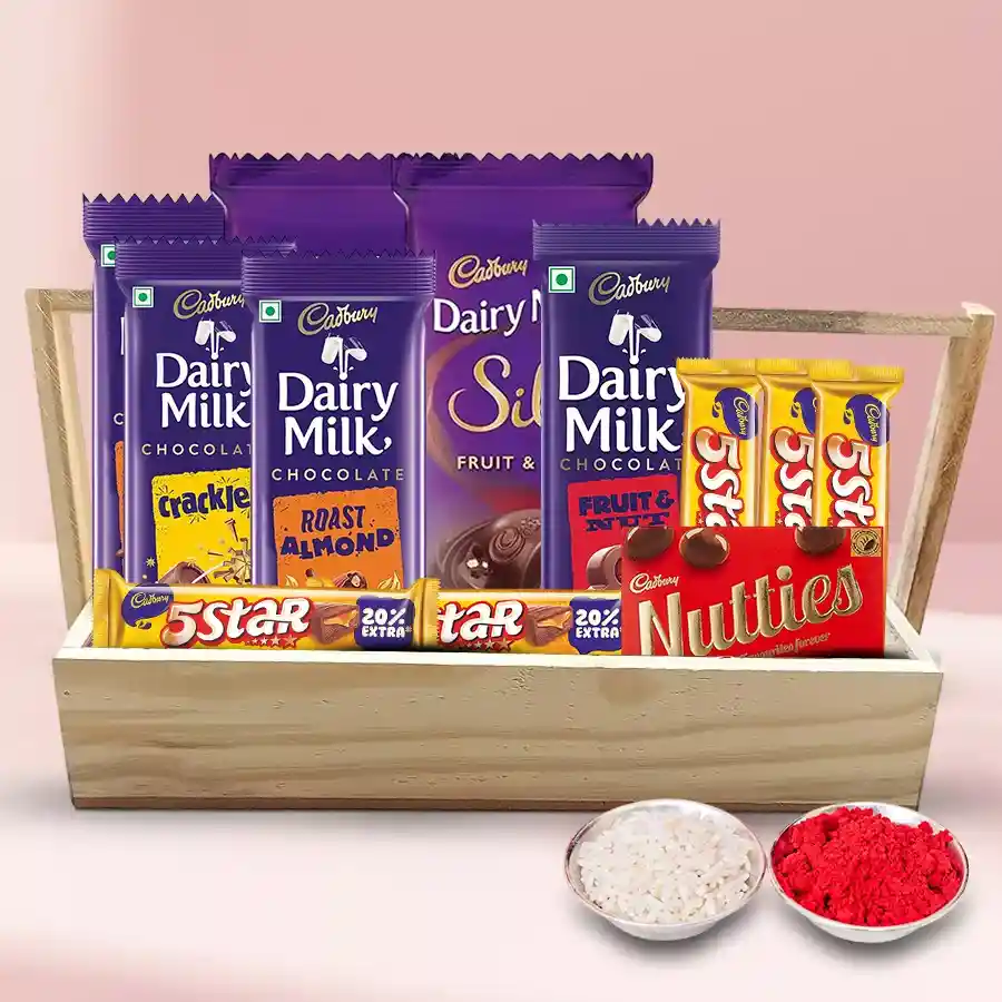 Cadbury Assortment Tray featuring Dairy Milk Silk, Roast Almond, Crackle, Fruit n Nut, Cadbury Nutties, and Five Star bars arranged on a stylish wooden tray with Bhai Dooj Tika N Chawal.