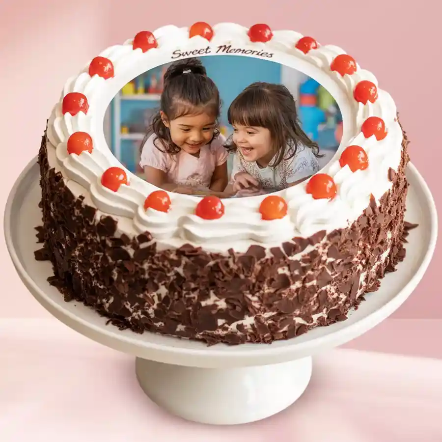 A beautifully decorated Enchanting Round Black Forest Cake with whipped cream and red cherries, personalized with a custom photo on top.