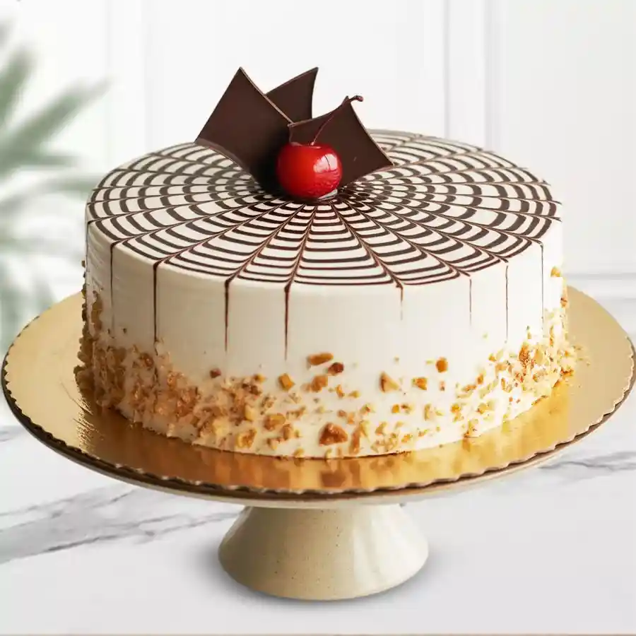 Butterscotch Bliss Cake with cream frosting, chocolate swirls, and butterscotch chips. Perfect eggless dessert for celebrations.