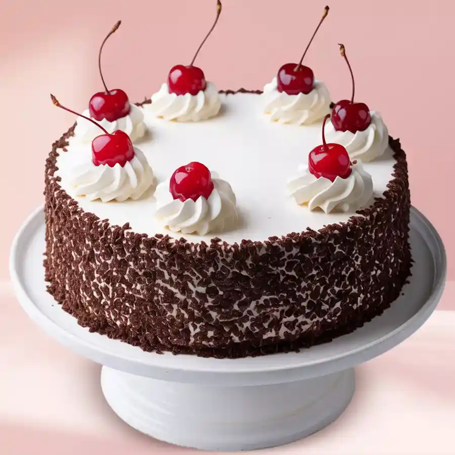 Heartfelt Eggless Black Forest Cake with heart and flower design, featuring chocolate sponge base and whipped cream topping.