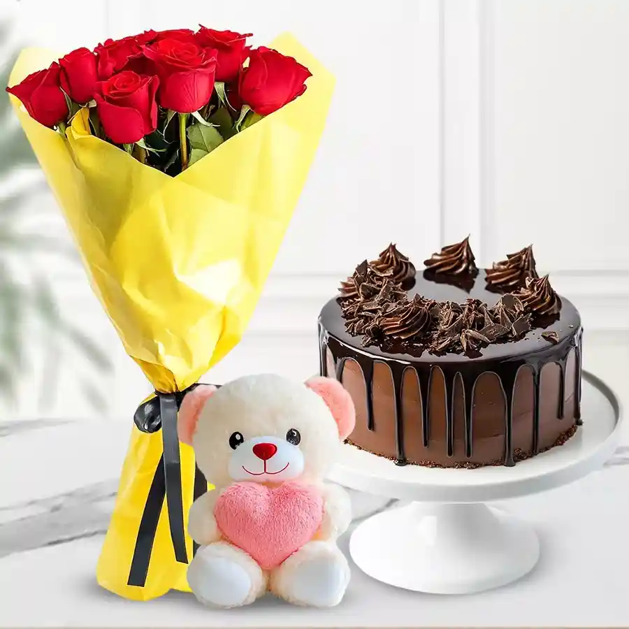 Chocolate cake, red rose bouquet, and a small teddy bear gift combo.