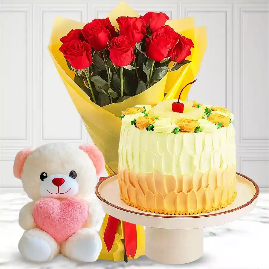 Charming gift combo featuring a Pineapple Cake, red roses bouquet, and a small teddy bear.