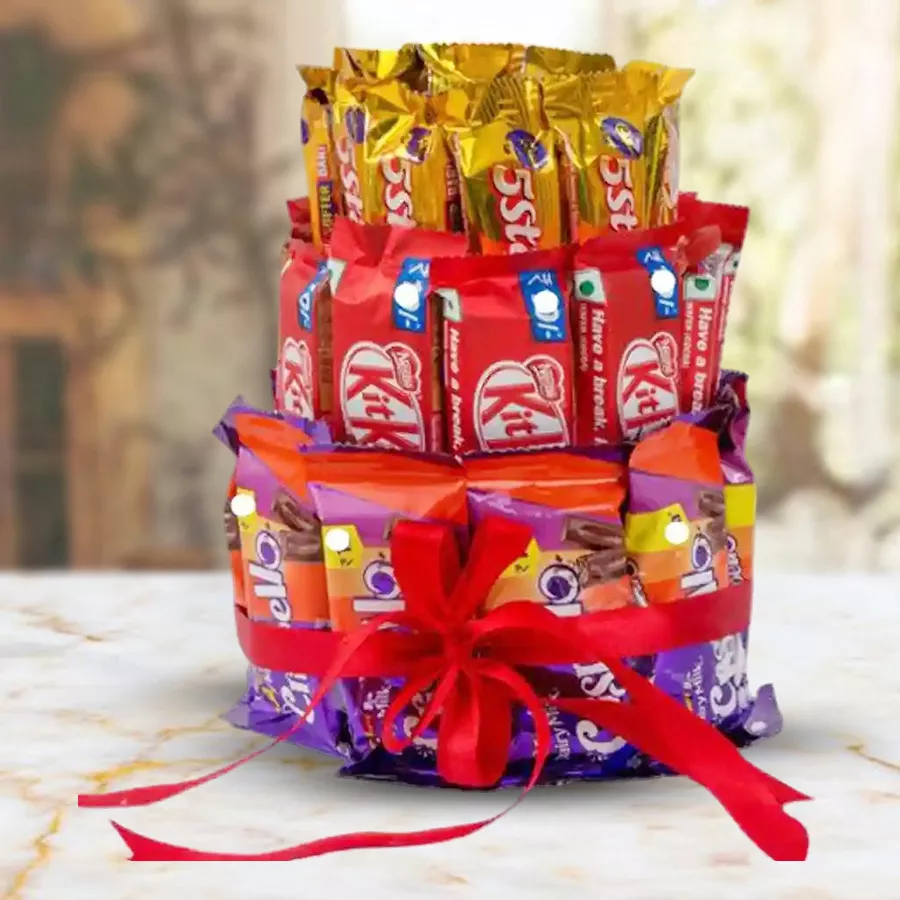 Three-layer chocolate arrangement featuring Nestlé KitKat, Cadbury 5 Star, and Cadbury Crispello, beautifully stacked and tied with a red ribbon.