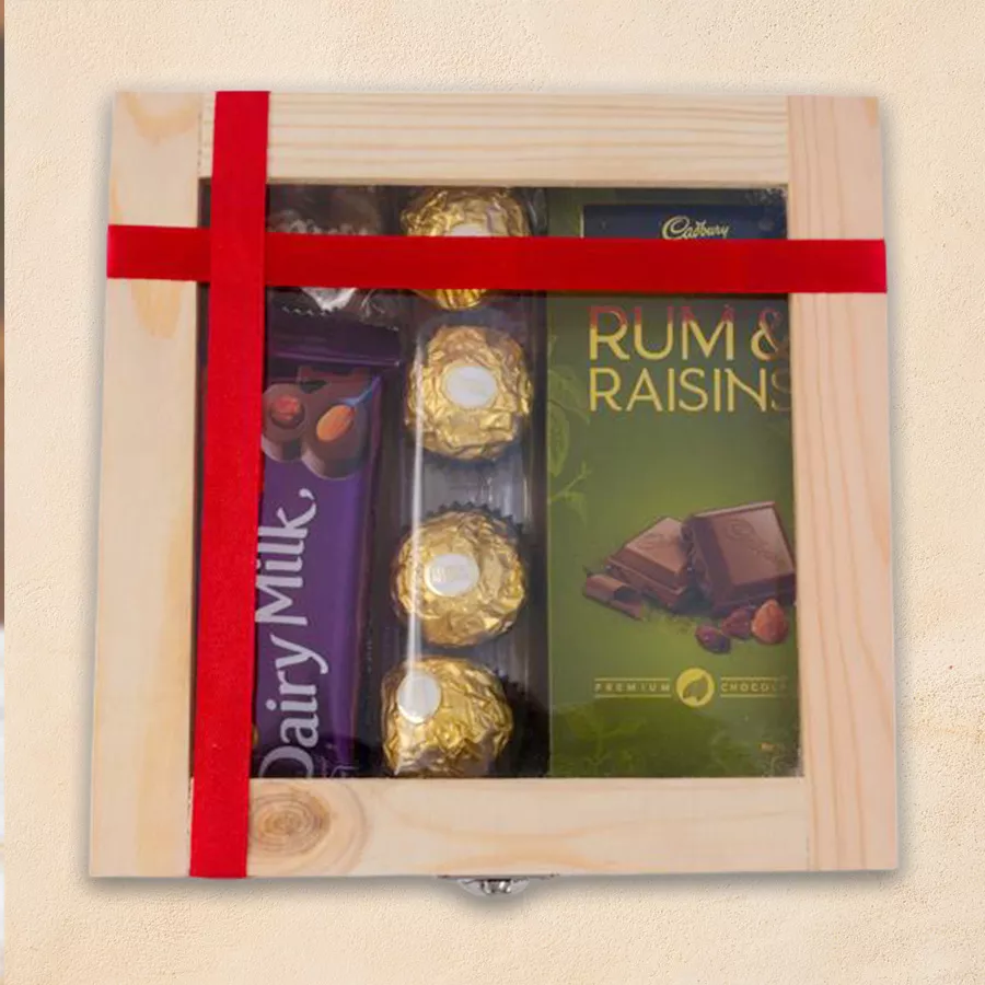 Wooden gift box filled with assorted chocolates including Cadbury, Ferrero Rocher, and Temptation chocolates.