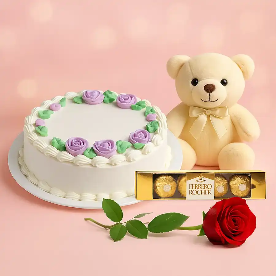 A lovely red rose, cuddly teddy bear, Ferrero Rocher chocolates, and an eggless vanilla cake beautifully arranged for a delightful celebration.