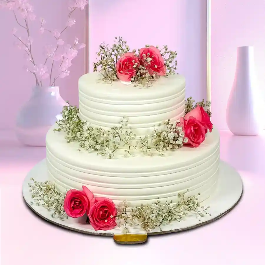 A delightful double-tier wedding cake weighing 5 kg, elegantly garnished with beautiful flowers, perfect for wedding celebrations.
