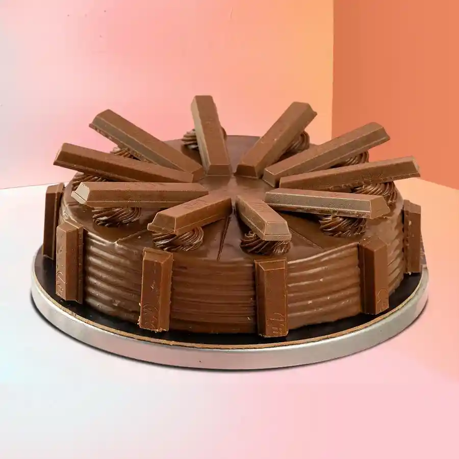 A delicious 1 lb KitKat Chocolate Cake featuring a rich chocolate base and crunchy KitKat pieces, perfect for sharing moments of joy.