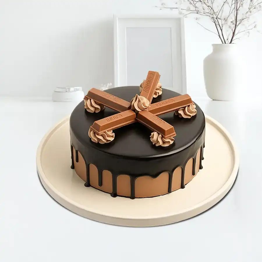 A beautifully decorated 1/2 kg Kitkat Cake, designed to spread joy and delight at celebrations.