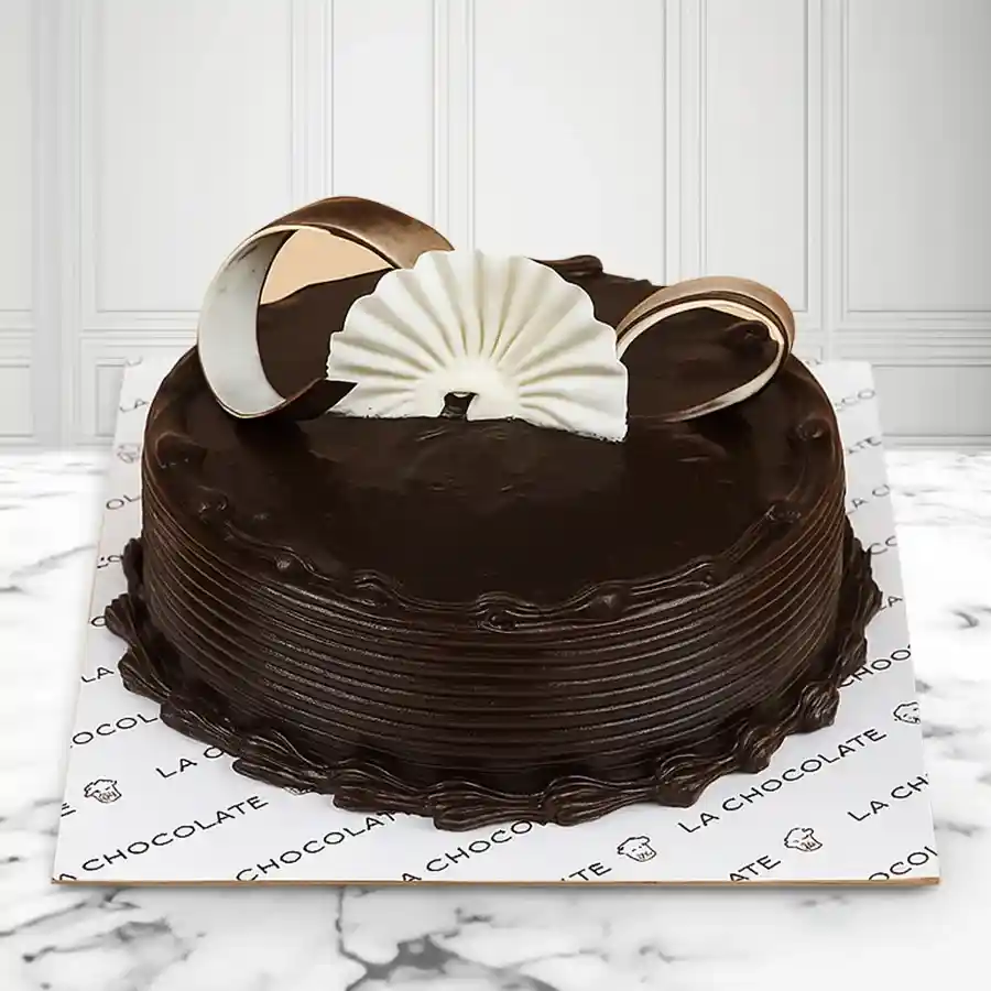 A luxurious truffle cake featuring dense chocolate layers and a silky ganache, perfect for celebrations or personal indulgence.