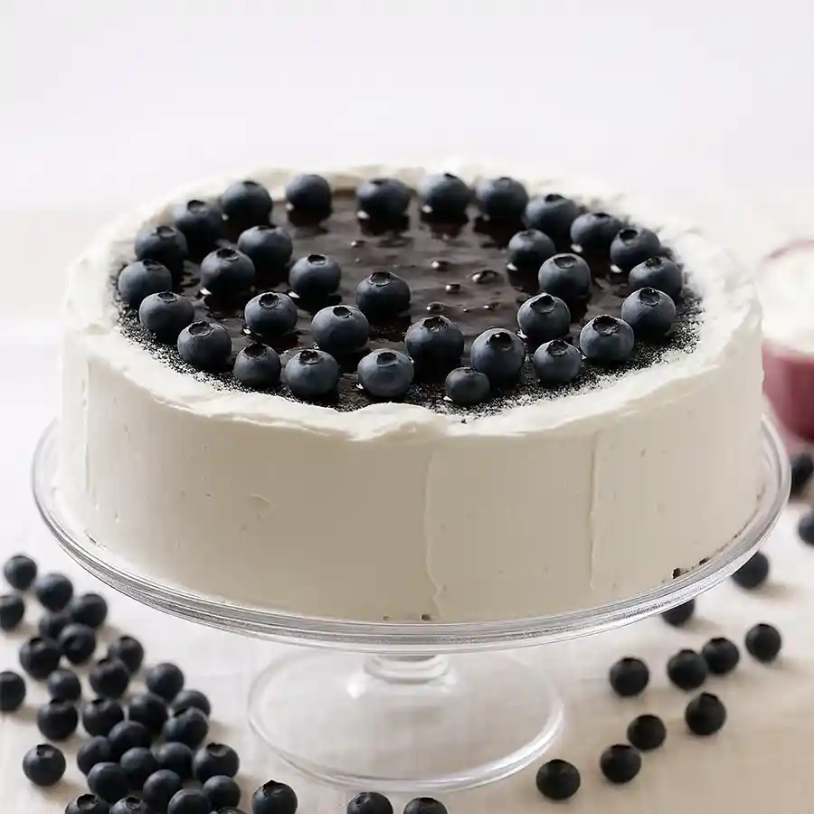 A 1/2 kg Blueberry Cream Cake featuring luscious blueberry filling and cream frosting, ideal for celebrations and special moments.