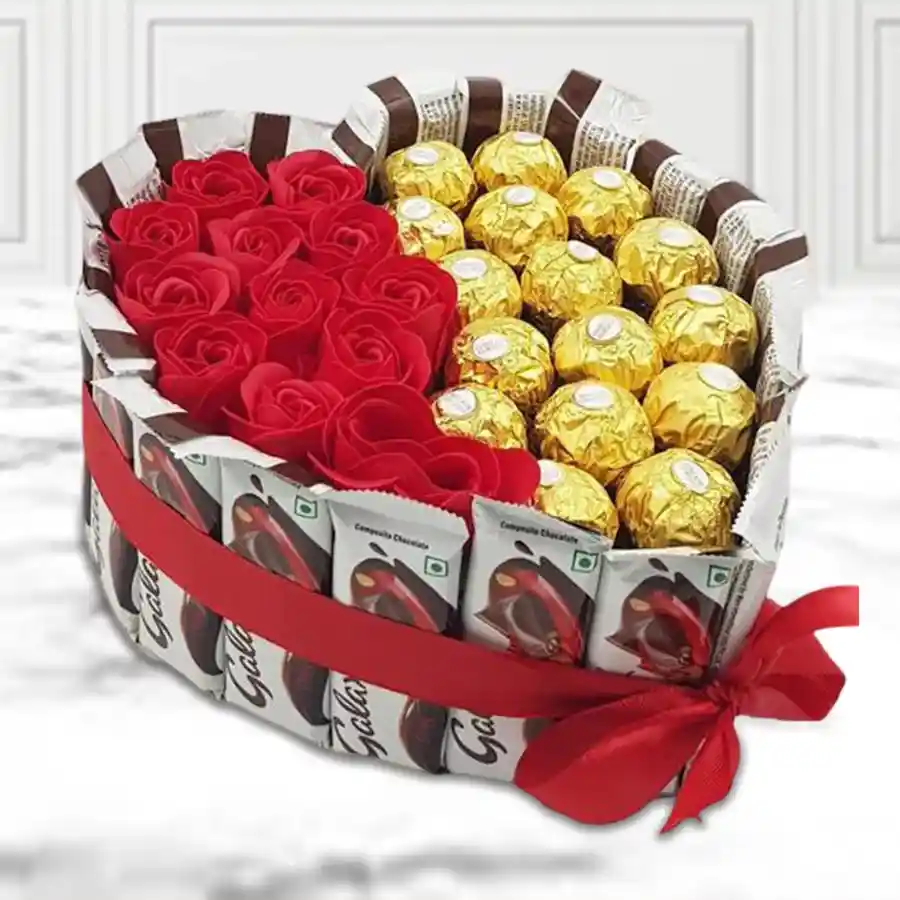 Heart-shaped arrangement of Ferrero Rocher chocolates, Galaxy Chocolate Bars, and artificial roses