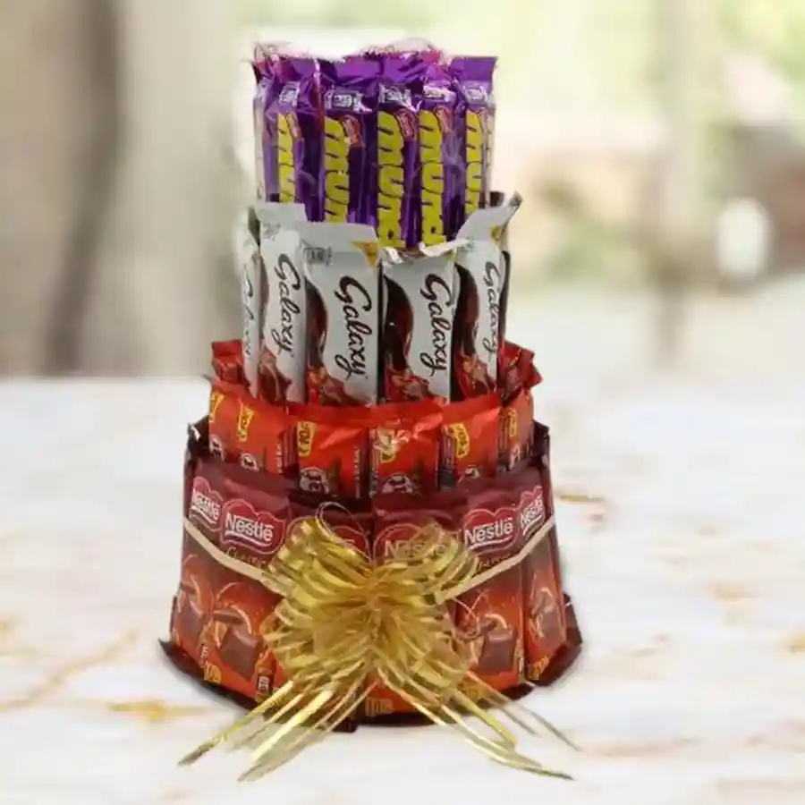 A beautiful 4-tier chocolate tower arrangement featuring Munch Wafers, Galaxy bars, Kit Kats, and Nestle chocolates.